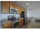 Modern kitchen featuring stainless steel appliances and warm wood cabinetry at 350 N Meridian St # 505, Indianapolis, IN 46204