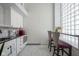 Modern kitchenette featuring white cabinets, black countertops, and stylish bar seating with geometric pattern on bar stools at 350 N Meridian St # 505, Indianapolis, IN 46204