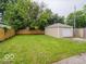 Spacious backyard featuring a well-maintained lawn and a detached one-car garage at 3558 N Gladstone Ave, Indianapolis, IN 46218
