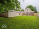 Large fenced backyard with detached garage and two-story brick home at 3558 N Gladstone Ave, Indianapolis, IN 46218
