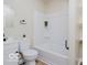 Modern bathroom features a white vanity, black fixtures, toilet, and a shower-tub combo at 3558 N Gladstone Ave, Indianapolis, IN 46218
