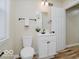 This bathroom features a white vanity, toilet, decorative mirror, and a convenient towel bar at 3558 N Gladstone Ave, Indianapolis, IN 46218
