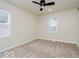 Bright bedroom features a ceiling fan, neutral walls, carpet, and window for ample natural light at 3558 N Gladstone Ave, Indianapolis, IN 46218