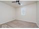 This bedroom offers a ceiling fan, a window for natural light, and neutral carpet at 3558 N Gladstone Ave, Indianapolis, IN 46218
