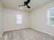 This bedroom provides a window, neutral walls, ceiling fan, and carpeted floor at 3558 N Gladstone Ave, Indianapolis, IN 46218