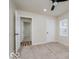 Well-lit bedroom with a ceiling fan, neutral walls, carpet, windows and view into other room at 3558 N Gladstone Ave, Indianapolis, IN 46218