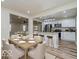Open dining area with a view of a kitchen featuring stainless steel appliances and a kitchen island at 3558 N Gladstone Ave, Indianapolis, IN 46218