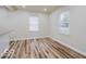 Bright living area featuring wood-look flooring and two windows providing natural light at 3558 N Gladstone Ave, Indianapolis, IN 46218
