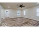 Well-lit living room with new flooring, a modern ceiling fan, and a view of the front entrance at 3558 N Gladstone Ave, Indianapolis, IN 46218