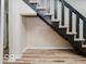 View of the home's staircase highlighting the wood-look floors and dark banister at 3558 N Gladstone Ave, Indianapolis, IN 46218