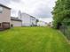 Large grassy backyard enclosed by a chain-link fence at 3734 Lacebark Dr, Indianapolis, IN 46235