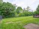 Private backyard with mature trees and lawn, enclosed by a chain-link fence at 3734 Lacebark Dr, Indianapolis, IN 46235