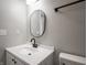 Close-up of bathroom vanity, with modern sink and faucet and mirror at 3734 Lacebark Dr, Indianapolis, IN 46235