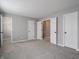 Spacious bedroom with carpeted floors and multiple doorways at 3734 Lacebark Dr, Indianapolis, IN 46235