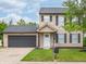 Charming two-story home featuring a well-kept lawn, attached garage, and neutral siding at 3734 Lacebark Dr, Indianapolis, IN 46235