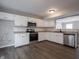 Cozy kitchen with white cabinets, hardwood floors, stainless steel appliances and countertops at 3734 Lacebark Dr, Indianapolis, IN 46235