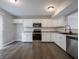 Well-lit kitchen featuring white cabinetry, stainless steel appliances, and tiled backsplash at 3734 Lacebark Dr, Indianapolis, IN 46235