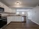New kitchen featuring white cabinets, hardwood floors, and stainless steel dishwasher at 3734 Lacebark Dr, Indianapolis, IN 46235