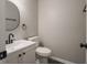 Charming powder room featuring modern fixtures, oval mirror, and elegant design at 3734 Lacebark Dr, Indianapolis, IN 46235