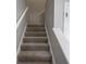 Carpeted staircase featuring white railing and trim at 3734 Lacebark Dr, Indianapolis, IN 46235