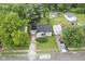 Aerial view of the home with an established yard, driveway, and neighborhood setting at 400 E 34Th St, Anderson, IN 46013