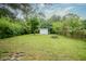 Large backyard with a fire pit and storage shed offers outdoor living at 400 E 34Th St, Anderson, IN 46013