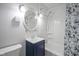 Cozy bathroom featuring a blue vanity with a classic shower and tub combination at 400 E 34Th St, Anderson, IN 46013