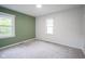 Bedroom with gray walls, green accent wall, two windows, and plush carpet at 400 E 34Th St, Anderson, IN 46013