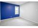 Bedroom with gray walls, blue accent wall, one window, and plush carpet at 400 E 34Th St, Anderson, IN 46013