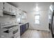 Bright kitchen featuring white cabinets, stainless steel appliances, and ample counter space at 400 E 34Th St, Anderson, IN 46013
