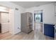 Bright kitchen with stainless steel refrigerator and hardwood flooring, next to laundry room at 400 E 34Th St, Anderson, IN 46013