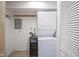Cozy laundry room featuring a stacked washer and dryer and wall hooks for added storage at 400 E 34Th St, Anderson, IN 46013