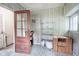 Bright sunroom with patterned linoleum, open glass door and vintage shelving at 400 E 34Th St, Anderson, IN 46013
