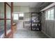 Bright sunroom with patterned linoleum, lots of natural light and shelves for storage at 400 E 34Th St, Anderson, IN 46013