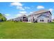 Large backyard features a well-maintained lawn, patio, dining area, and gazebo for relaxing outdoor living at 4163 Ironclad Dr, Bargersville, IN 46106