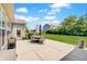 A concrete patio and dining set invite outdoor enjoyment, with lush green lawn and a built in grill at 4163 Ironclad Dr, Bargersville, IN 46106
