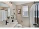 Neutral-toned bathroom features a modern vanity, elegant mirror, and shower with a stylish curtain at 4163 Ironclad Dr, Bargersville, IN 46106