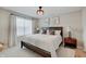A stylish bedroom features a large bed, neutral tones, and modern window treatments for a serene atmosphere at 4163 Ironclad Dr, Bargersville, IN 46106