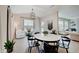Inviting dining area boasts modern chandelier, natural light, a stylish round table, and cozy seating at 4163 Ironclad Dr, Bargersville, IN 46106