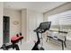 Bright exercise room with natural light, a stationary bike, workout bench and view to the outdoor patio at 4163 Ironclad Dr, Bargersville, IN 46106