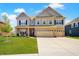 Beautiful two-story home with brick and siding exterior, well-manicured lawn, and a two-car garage on a sunny day at 4163 Ironclad Dr, Bargersville, IN 46106