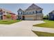 Inviting two-story home with a lush lawn, front porch seating, and a spacious driveway leading to a three-car garage at 4163 Ironclad Dr, Bargersville, IN 46106