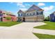 Striking two-story home features a brick and siding facade, a three-car garage, and a large driveway at 4163 Ironclad Dr, Bargersville, IN 46106