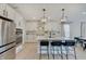 Bright kitchen with white cabinets, stainless steel appliances, and a spacious island with bar stools at 4163 Ironclad Dr, Bargersville, IN 46106