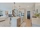 Open kitchen features a large island with seating, stainless steel appliances, and modern pendant lighting at 4163 Ironclad Dr, Bargersville, IN 46106