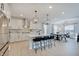 Bright, modern kitchen with stainless steel appliances, white cabinetry, large island with seating, and pendant lighting at 4163 Ironclad Dr, Bargersville, IN 46106