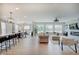Expansive open living area with modern furnishings, a fireplace, kitchen island, and a dining area at 4163 Ironclad Dr, Bargersville, IN 46106