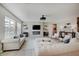 Bright living room with modern fireplace, large windows, stylish sofas and ample seating for entertaining guests at 4163 Ironclad Dr, Bargersville, IN 46106