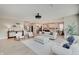 Open-concept living room with modern furniture, view to kitchen and dining area, and lots of natural light at 4163 Ironclad Dr, Bargersville, IN 46106