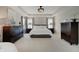 Serene main bedroom showcasing a tray ceiling, dressers, and soft lighting at 4163 Ironclad Dr, Bargersville, IN 46106